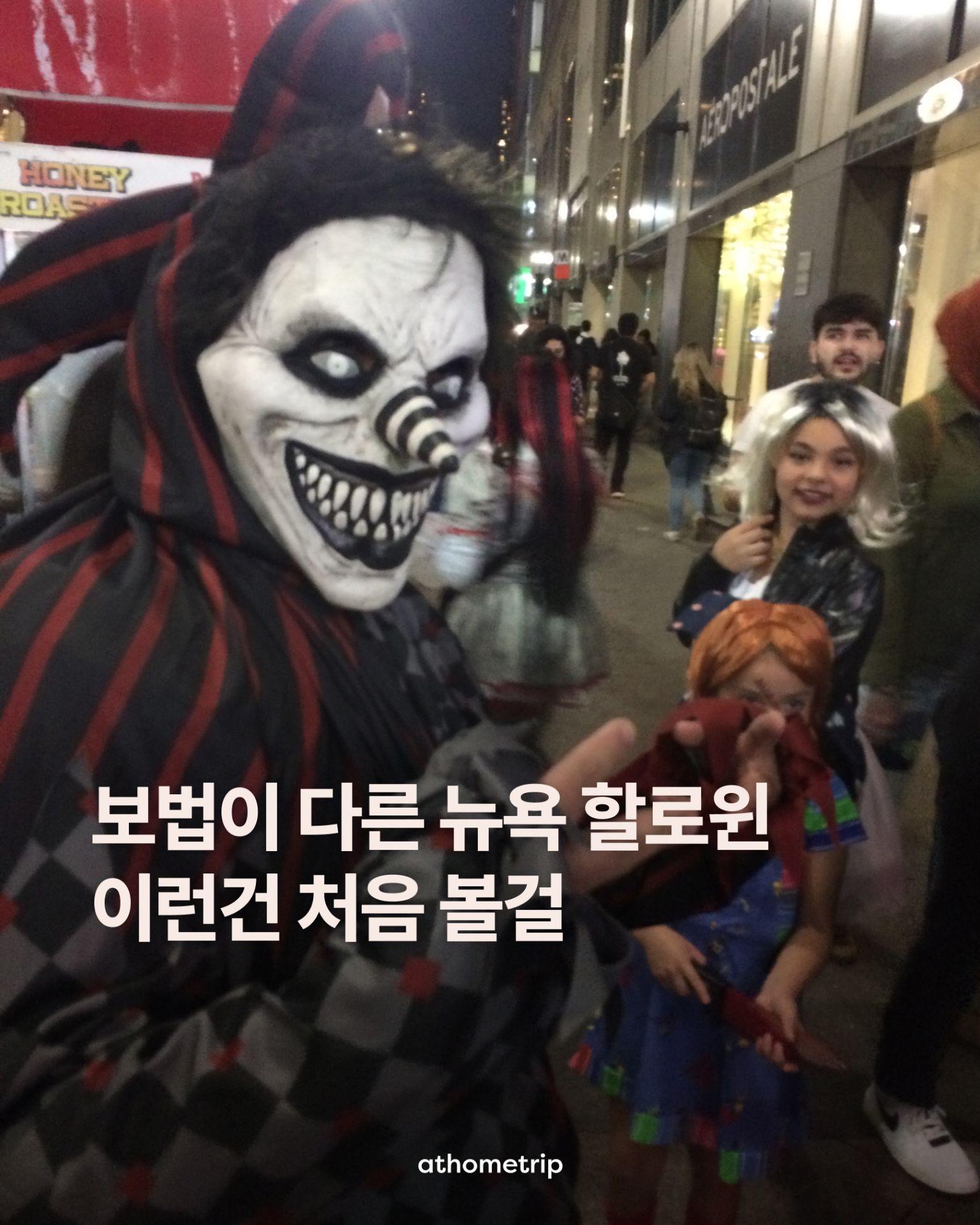 밤거리에서 다양한 마스크와 의상을 착용한 사람들이 건물 앞에 모여 있는 모습